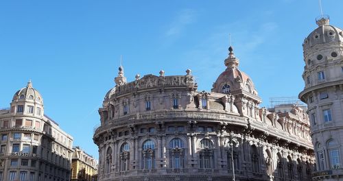 Low angle view of buildings against blue sky