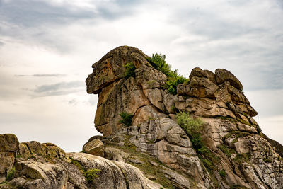 Low angle view of rock formation against sky