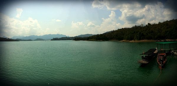 Scenic view of calm lake against cloudy sky