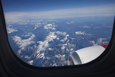 Cropped image of airplane wing over landscape