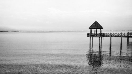 Lifeguard hut in sea against sky