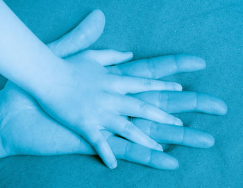 High angle view of woman touching blue eyes