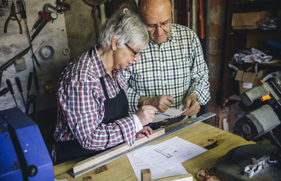 Senior couple working at workshop