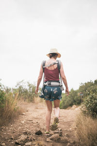 Rear view of man walking on field