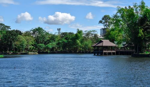 Scenic view of lake by building against sky