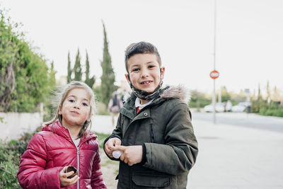 Portrait of happy friends standing outdoors