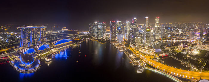 Illuminated cityscape against sky at night