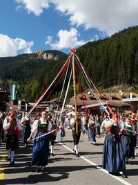 Group of people in city against sky