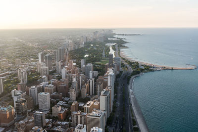 High angle view of buildings by sea against sky