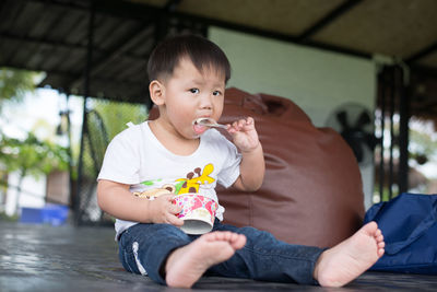 Portrait of cute baby girl sitting on floor