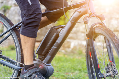 Low section of man cycling on bicycle