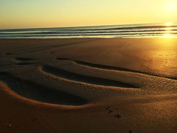 Scenic view of beach at sunset