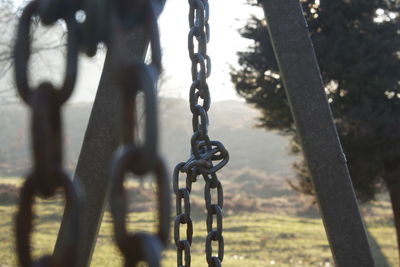 Close-up of chain swing in playground
