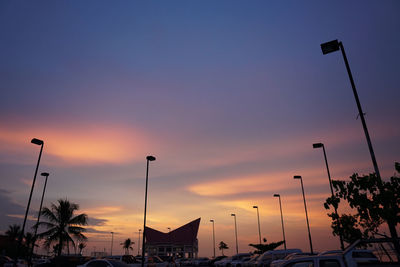 Low angle view of silhouette street against sky at sunset