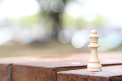 Close-up of queen on wooden table