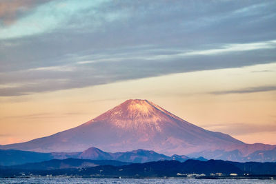 Scenic view of snowcapped mountains against sky during sunrise