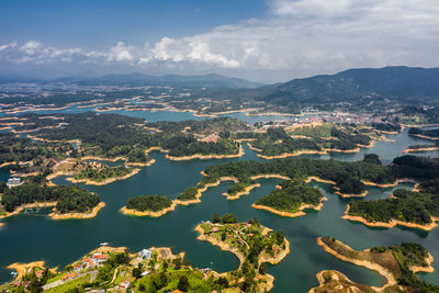 High angle view of sea and mountains against sky