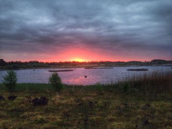 Scenic view of lake against cloudy sky