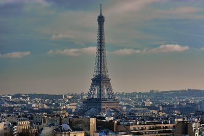Eiffel tower from arc de triomphe in city against sky