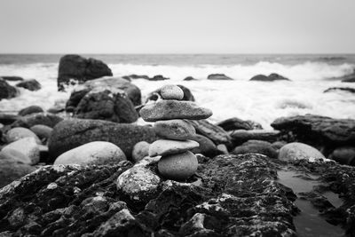 Close-up of pebbles on beach against clear sky