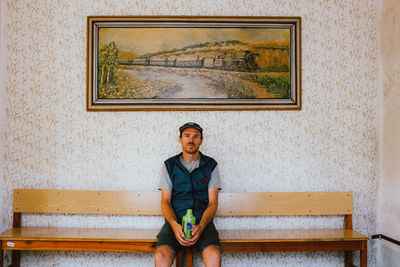 Portrait of a young man sitting on bench