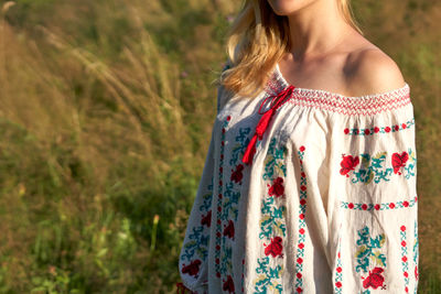 Midsection of woman standing on field