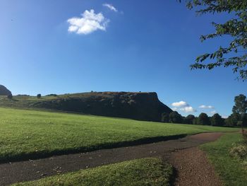 View of country road against blue sky