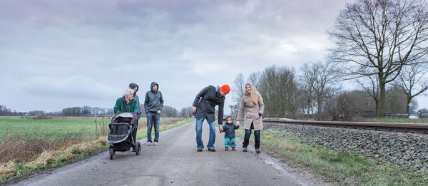 Family on road against sky