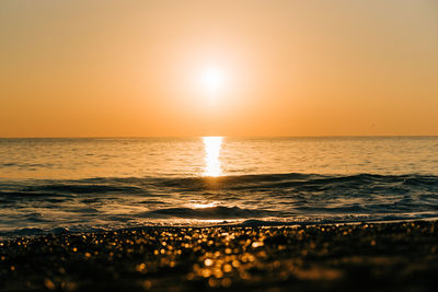 Scenic view of sea against clear sky during sunset