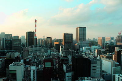 View of skyscrapers against cloudy sky