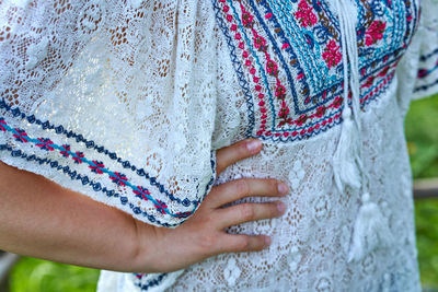 Midsection of woman standing against wall during winter