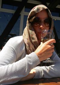 Portrait of a young woman drinking glass of wine