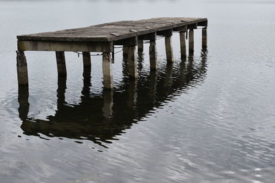 Concrete pier on lake by building