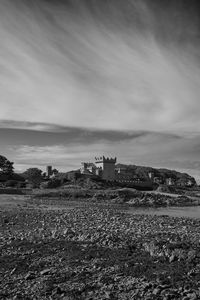 Low angle view of quintin castle against cloudy sky