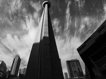 Low angle view of buildings against cloudy sky