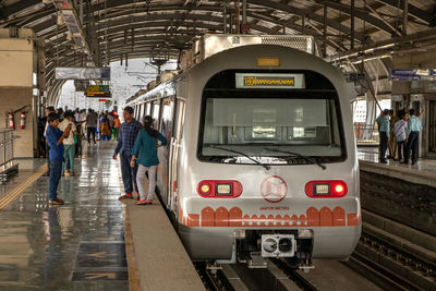 People at railroad station platform in city