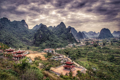 High angle view of buildings against cloudy sky