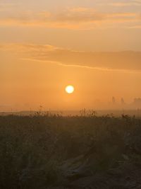 Scenic view of field against sky during sunset