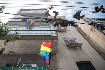 Low angle view of flags hanging on building