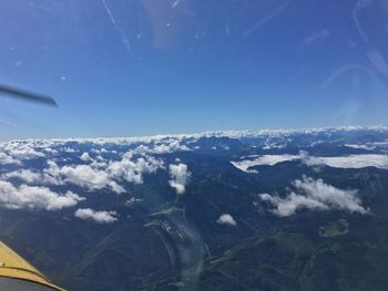 Aerial view of landscape against blue sky