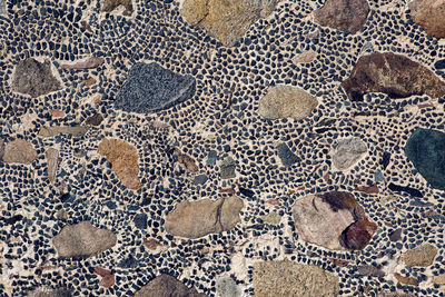 Different sizes of stone in the wall of the old building background