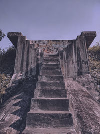 Low angle view of old staircase against sky