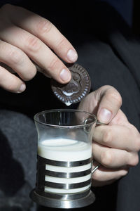 Cropped image of hand holding coffee cup