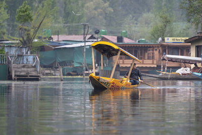 Boats moored in river