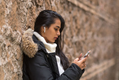 Young woman using mobile phone outdoors