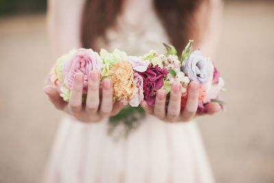 Close-up of woman holding floral garland