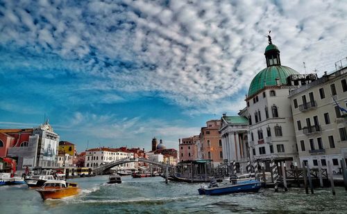 Buildings by grand canal in city