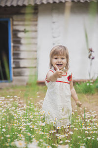 Portrait of cute girl blowing bubbles in park