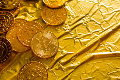 Close-up of bitcoins on golden paper