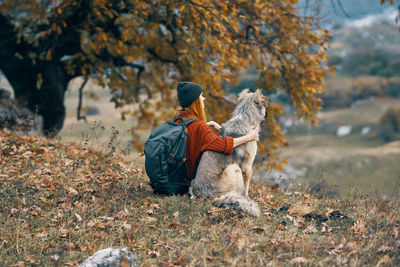 Rear view of person on field during autumn